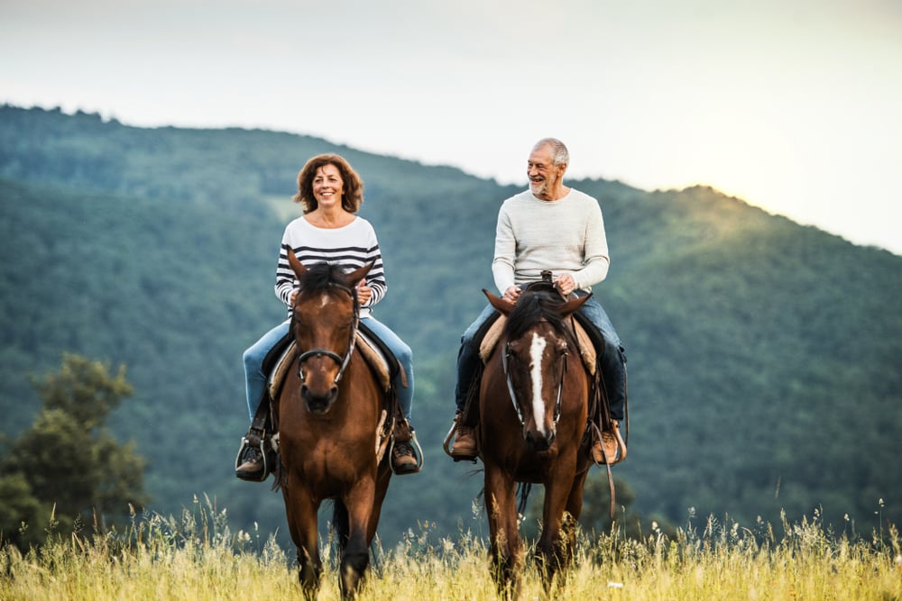 happy couple riding horses