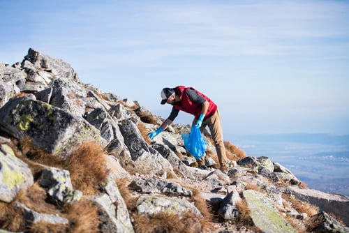 hiker picking up trash