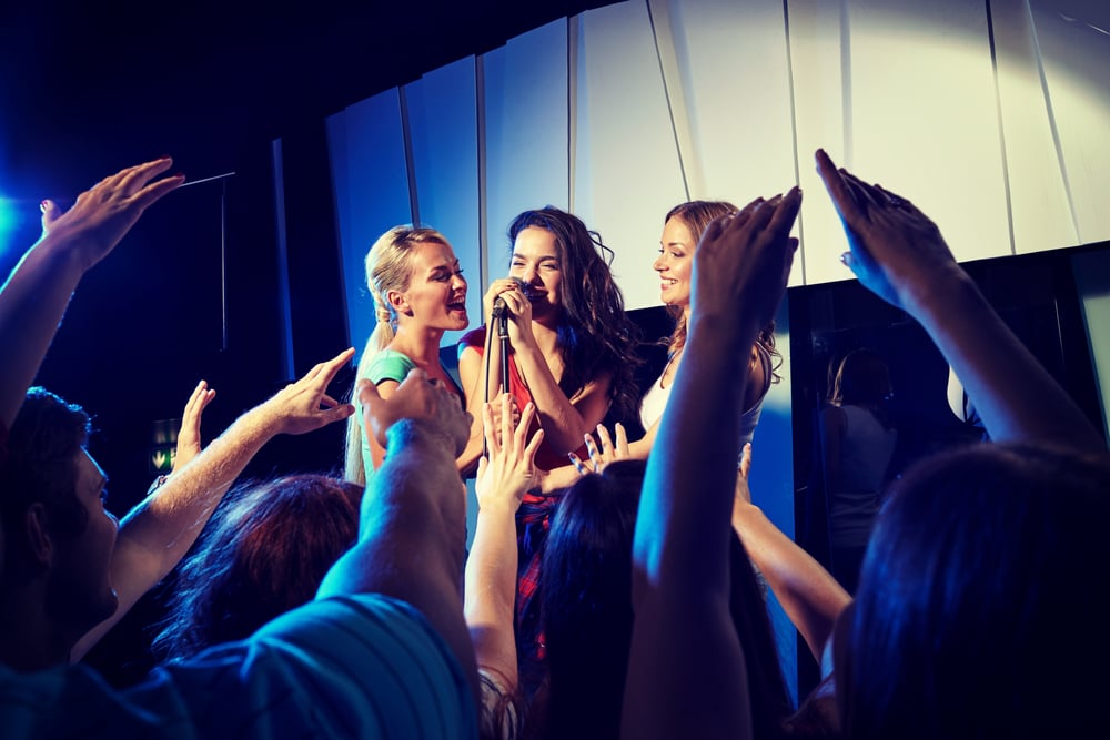 women singing karaoke